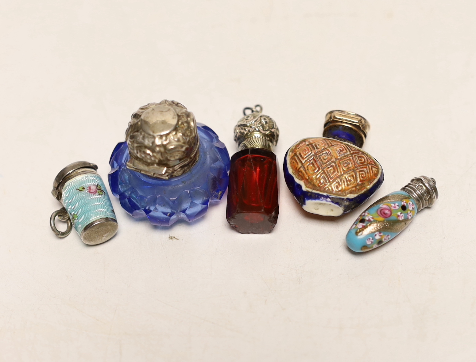 An Edwardian small silver and enamel scent bottle Birmingham, 1901, 29mm, two other small scent bottles and an enamelled thimble? holder.